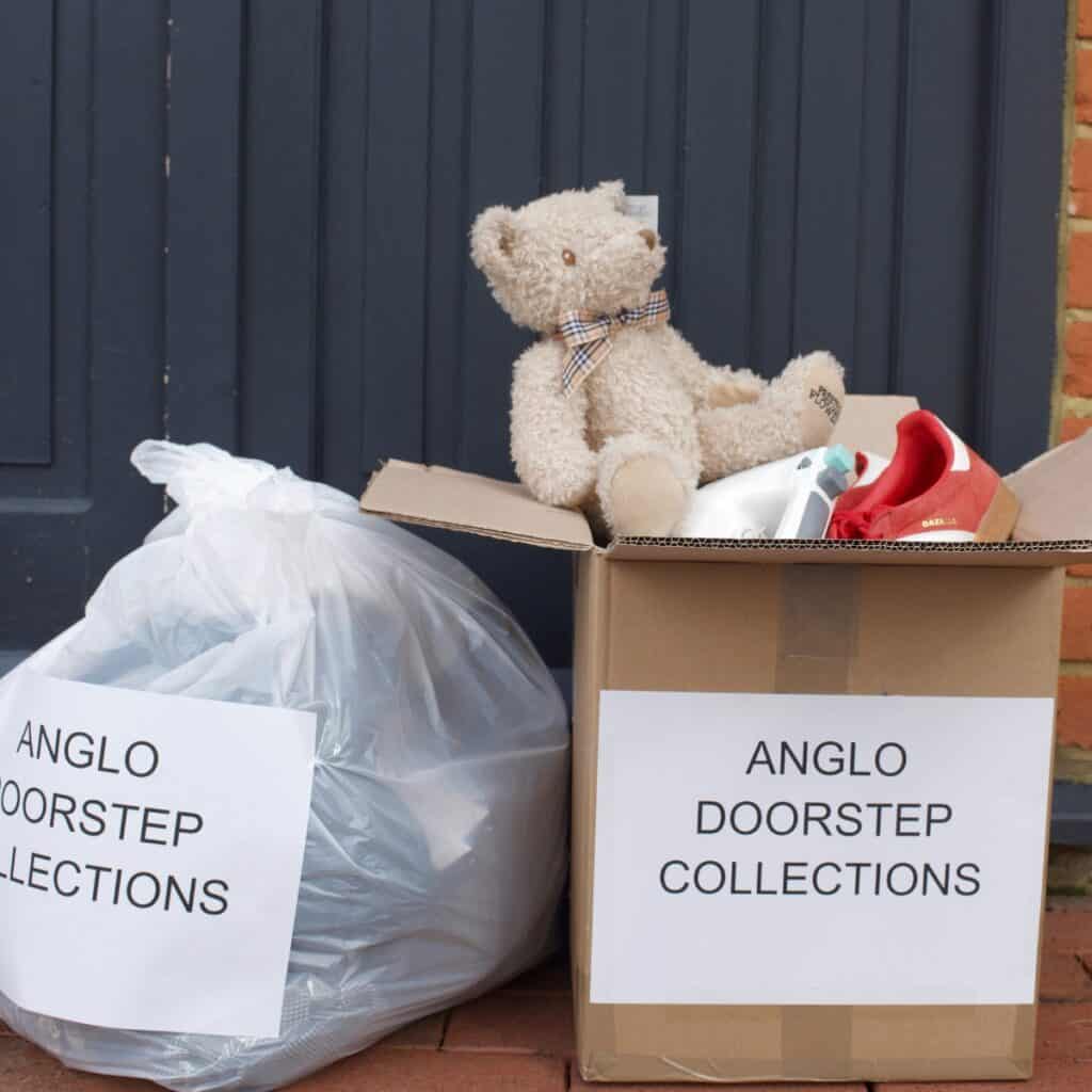 Box with teddy and shoes in for charity. Placed on the doorstep. Labelled for anglo doorstep collections.